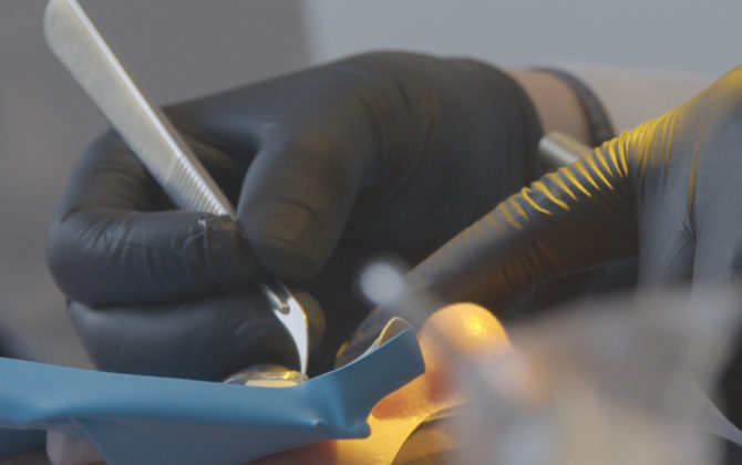 Dr. Nejad performing biomimetic dental procedure with rubber dam.